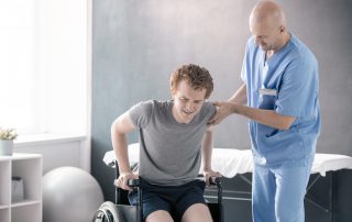 photo of a physical therapist and a patient in a wheelchair