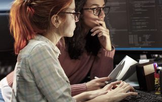 photo of two programmers staring intently at a monitor
